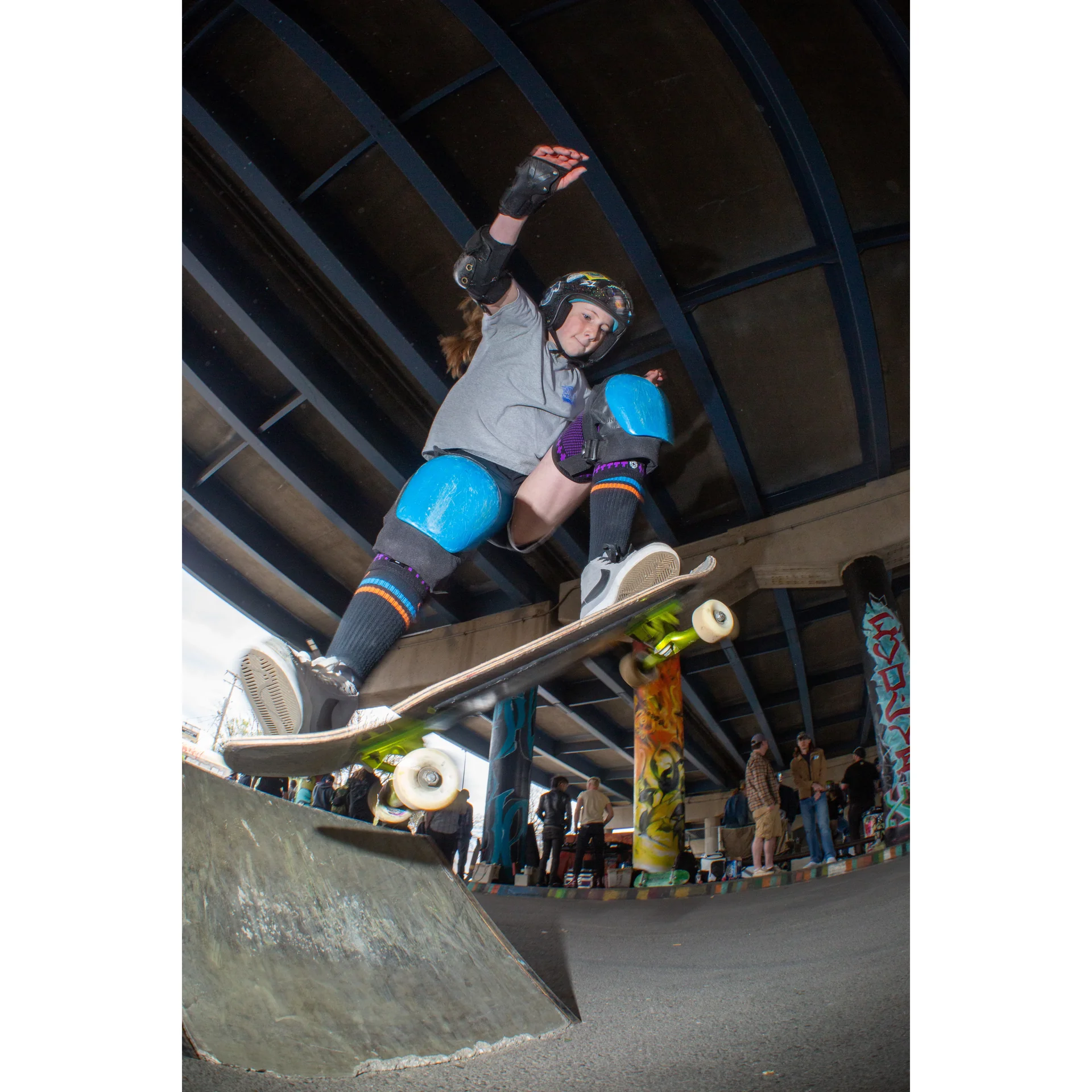 Bright photo of a kid skateboarding in full pads. Photo shot by Dylan Shanahan.